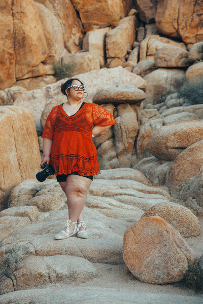 woman holding camera and standing