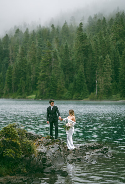 A bride and groom at Mowich Lake in Mt. Rainier National Park.