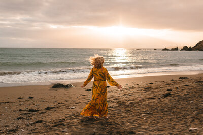 Tonja Mills photographed dancing at Challaborough Beach in Devon