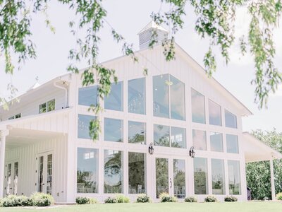 View of Dallas wedding venue Firefly gardens that showcases the tall windows on the back of the venue.