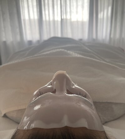 a woman receiving a facial