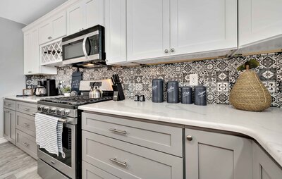 Stainless steel appliances and detailed backsplash in the kitchen of this 3-bedroom, 2.5 bathroom lake house with incredible view of Lake Belton located at Morgan's Point, near Rogers Park and Temple Lake Park.