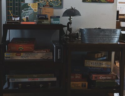 Stacked board games at Hillcrest Coffee