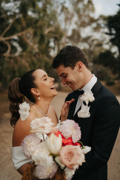 couple laughing during their portraits at Emu bottom Homestead