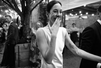 Man and woman in traditional Asian wedding garb kissing each other
