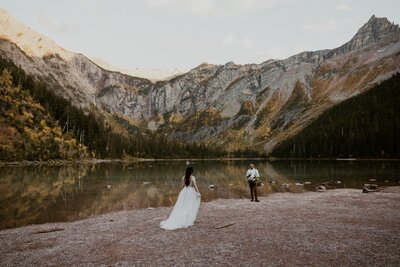 couple standing on rocks on the beach