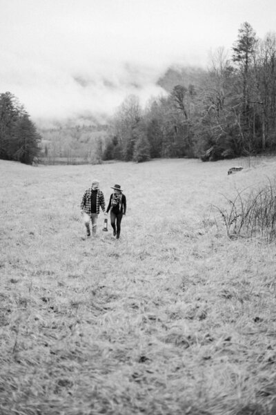 Couple holding lantern during their adventure session in the smoky mountains.