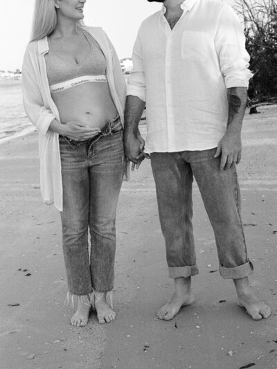 Couple holding hands on beach taken by Shelby Ann Photos, florida engagement photographers