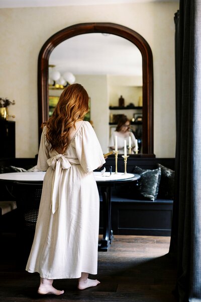 Monica-facing-mirror-holding-book