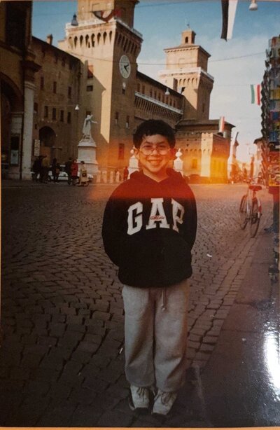 A young boy standing in a European street