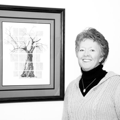 Black and white portrait of artist standing next to apple tree framed artwork