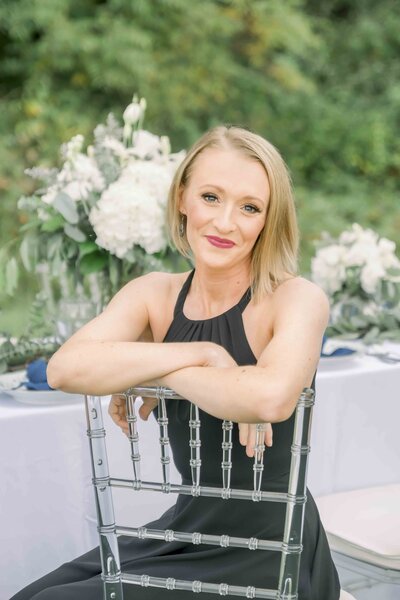 business owner posing in wedding chair