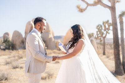 Joshua Tree Hidden Valley elopement ceremony with bride and groom exchanging vows during sunset