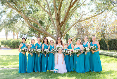 bride with bridesmaids with blue long dresses