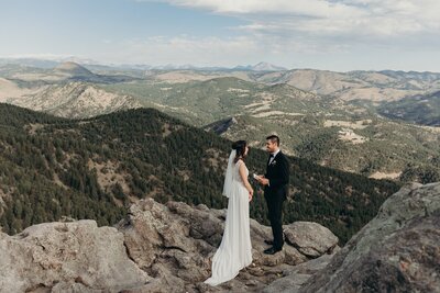 couple saying their vows on top of a mountain in boulder colorado