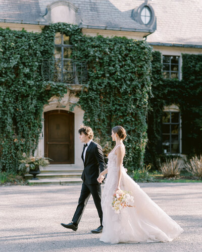 bride and groom in front of Greencrest Manor in Midwest