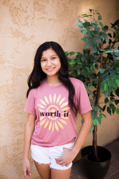 girl wearing you're worth it pink t-shirt