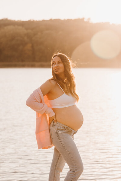 Pregnant woman posing near lake 