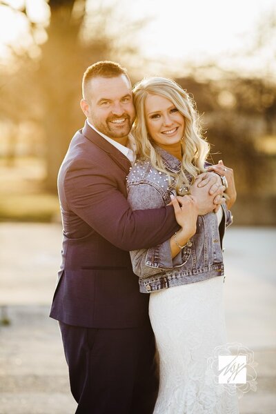 groom hugging bride from behind