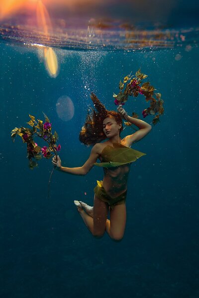Underwater image of woman in floral bikini photographed on Maui by Love + Water