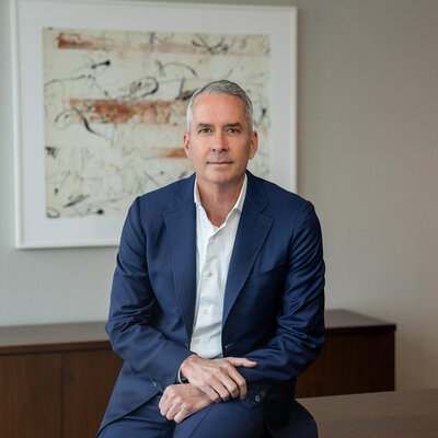 NYC executive portrait of senior corporate leader in navy suit with confident presence