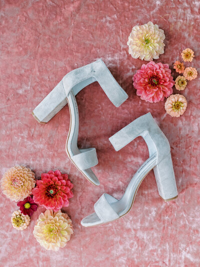 San Diego Wedding Photos Suede Grey Shoes styled with colorful dahlias on a rosy pink velvet back drop