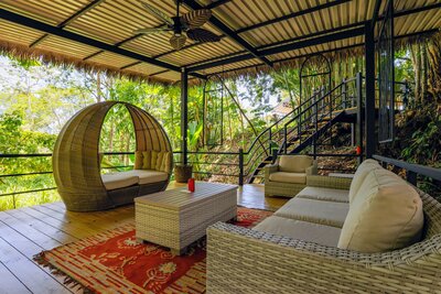 an outdoor living space with furniture at a retreat center in costa rica 