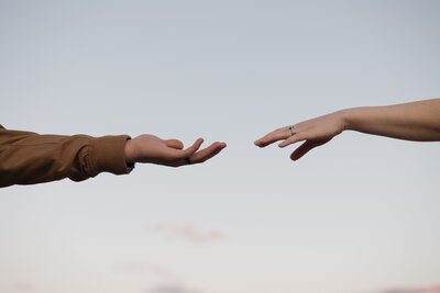 couples holding hands against sunset