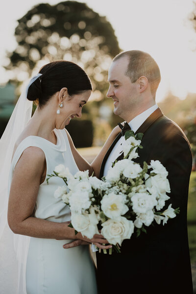 Elegant and timeless wedding flowers in a palette of classic white and green were designed by Sunshine Coast wedding florist Bloom & Bush for Bronte and Will's black tie Flaxton Gardens wedding