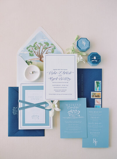 Luxury hawaiian wedding invitations styled with envelopes, watercolor drawings and ring boxes representing full service design and calligraphy by Life in Letters.