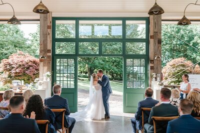 A bride and groom kissing after getting married at Flowerdale Estate