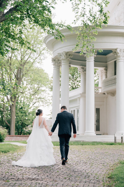 Bride smiles at Groom while saying their vows at the Lincoln, NE Wedding Venue, Arbor Day Farms. Photo by Lincoln NE Wedding Photographer, Anna Brace.