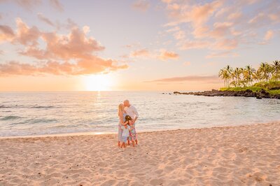 big island family portrait photography of young boy looking off camera at the beach at sunset in waikoloa