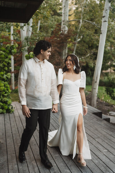 Bride and groom walking together outside their Big Sky home photographed by best montana wedding photographer frazier & co.