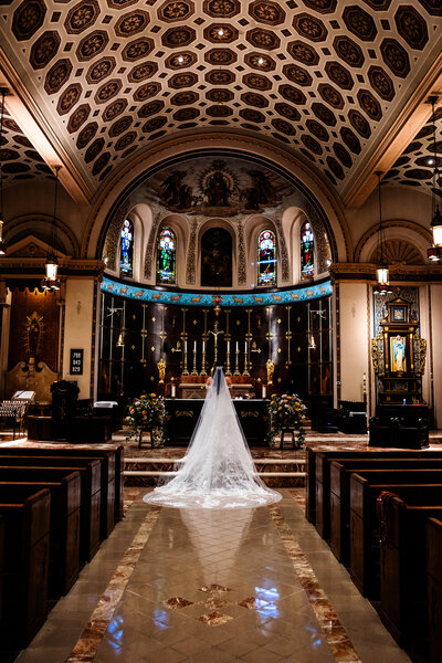a bride in an elaborate cathedral in connecticut on her wedding day