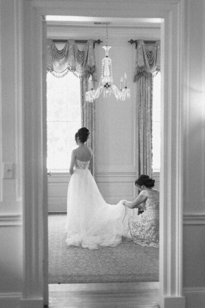 brides mom helping with dress