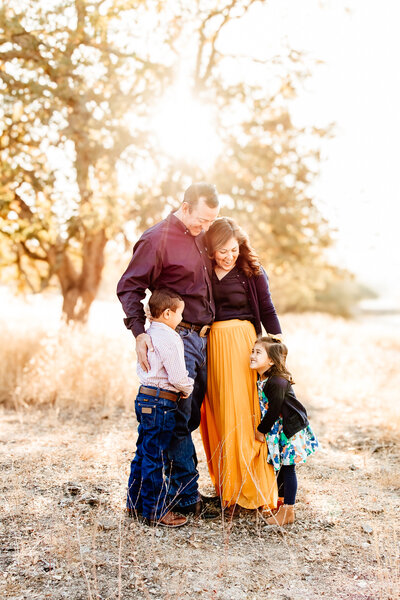 Family of 6 with their dog at sunset on Bishop's peak hill