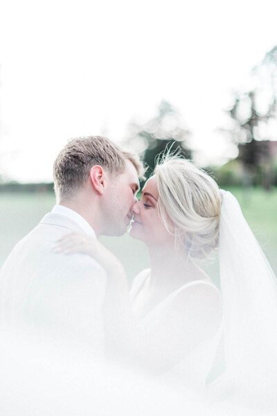 bride kissing her groom at chateau de varennes