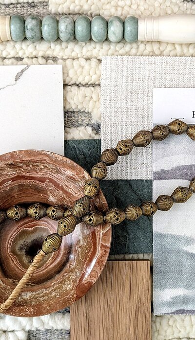 Japandi materials flat-lay -oak, honed limestone, linen, blackened steel, and clay for a livable zen palette.