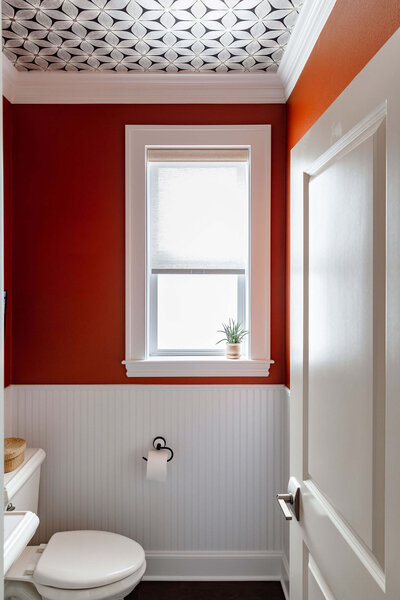 A peek into a bathroom featuring a patterned ceiling.