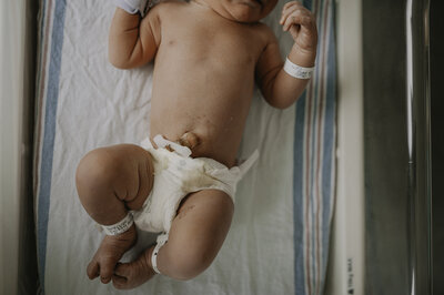 Verona B Photography captures baby details of a newborn – an adorable baby held in his daddy’s arms at an in-home newborn session near Akron, Ohio.