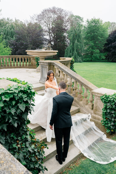 Newport Wedding Photographer | Rhode Island Caprio Captured Photography | Bride and Groom Smiling At Each Other With Pink With A Pink And White Florals