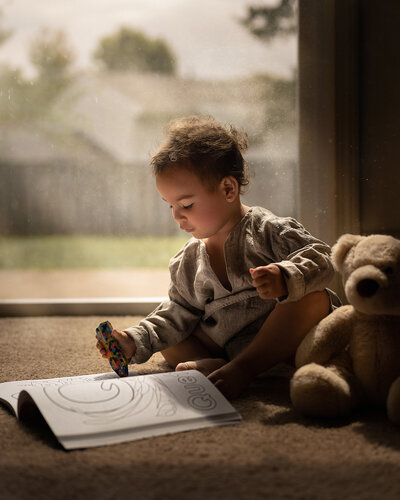 Child at home reading, photos by Iya Estrellado a Virginia Beach Child Photographer.