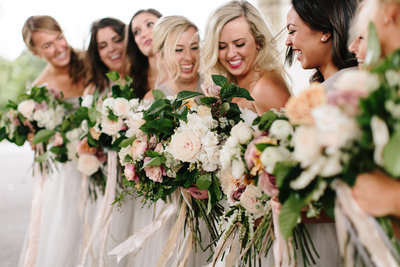 Bridesmaids in blush and grey chiffon dresses with Munster Rose bouquets