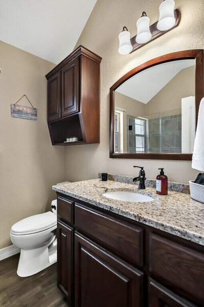 Master bathroom with granite counter tops in this three-bedroom, two-bathroom vacation rental lake house that sleeps eight just steps away from Stillhouse Hollow Lake in Belton, TX.