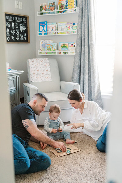 Parents playing with their two kids on the floor of their Lancaster, PA playroom during a lifestyle documentary session.