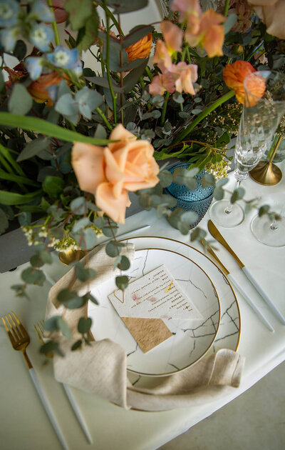 Peach roses and white plates wedding breakfast table decor