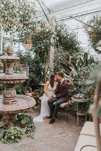 Lake Tahoe Elopement Photographer captures bride and groom kissing in greenhouse