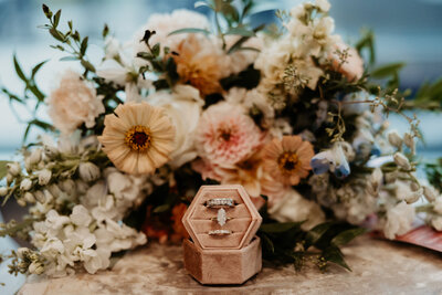 Wedding rings with bridal bouquet from The Blooming Basket