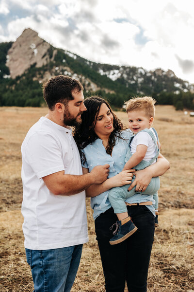 Denver Wedding Photographer captures family sitting on porch during outdoor family photos